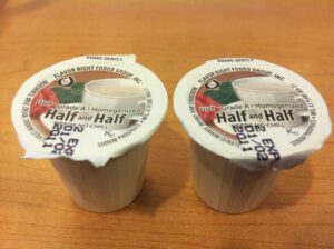 Two tiny cups of half and half
