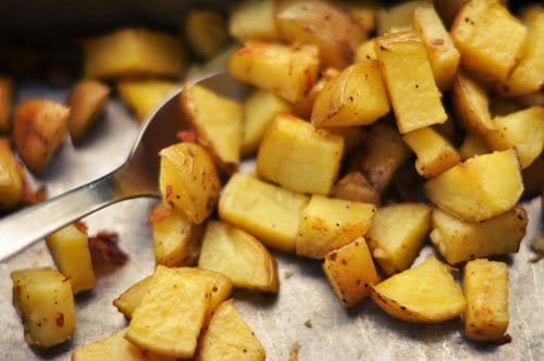Roasted potatoes and kitchen utensils